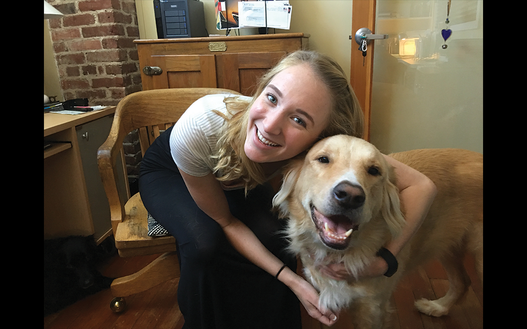 A3 Intern Avery Riggs with office dog Brantley